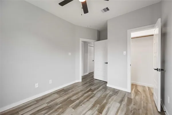 a view of a room with wooden floor
