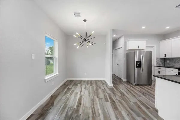 a view of a kitchen with a sink and refrigerator