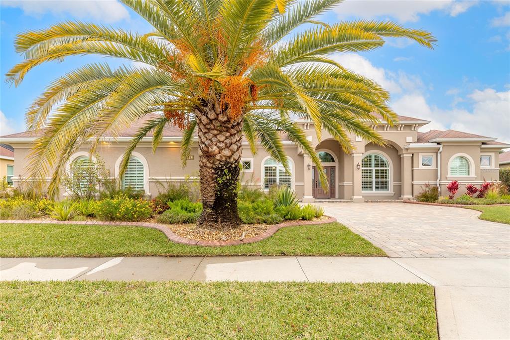 3343 West Locanda Circle New Smyrna Beach, FL 32168 - Photo 13 of 55 a front view of a house with a garden