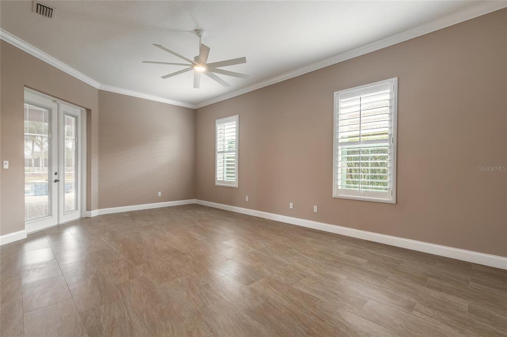 3343 West Locanda Circle New Smyrna Beach, FL 32168 - Photo 17 of 55 a view of an empty room with wooden floor and window