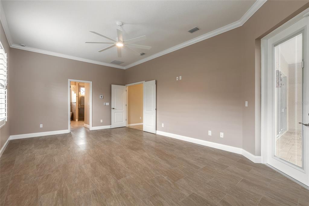 3343 West Locanda Circle New Smyrna Beach, FL 32168 - Photo 18 of 55 a view of an empty room with wooden floor and window