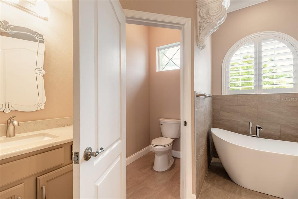 3343 West Locanda Circle New Smyrna Beach, FL 32168 - Photo 23 of 55 a bathroom with a toilet bathtub and sink