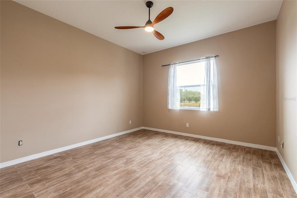 3343 West Locanda Circle New Smyrna Beach, FL 32168 - Photo 24 of 55 wooden floor in an empty room with a window