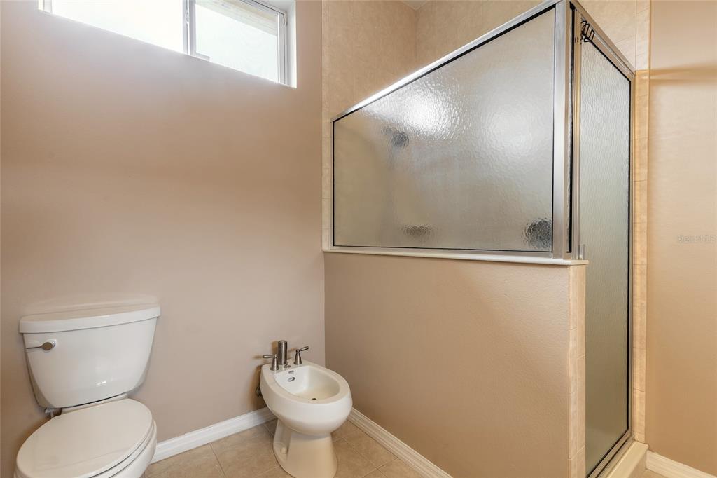 3343 West Locanda Circle New Smyrna Beach, FL 32168 - Photo 27 of 55 a bathroom with a toilet and a mirror