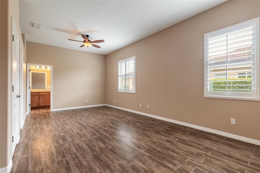 3343 West Locanda Circle New Smyrna Beach, FL 32168 - Photo 29 of 55 a view of empty room with wooden floor and fan