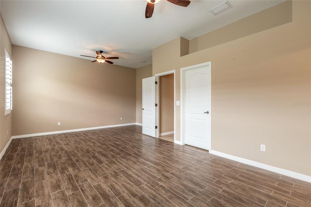 3343 West Locanda Circle New Smyrna Beach, FL 32168 - Photo 30 of 55 wooden floor in an empty room with a window