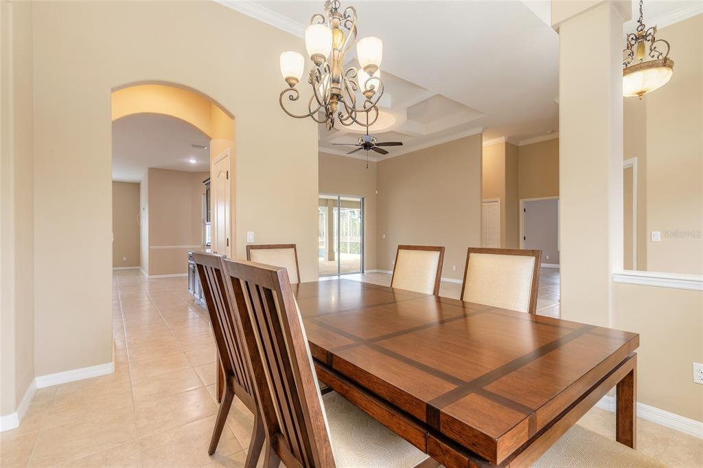 3343 West Locanda Circle New Smyrna Beach, FL 32168 - Photo 41 of 55 a view of a dining room with furniture and a chandelier