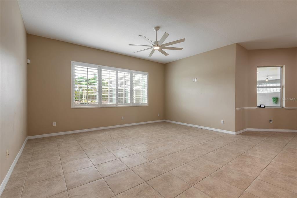 3343 West Locanda Circle New Smyrna Beach, FL 32168 - Photo 43 of 55 an empty room with windows and fan
