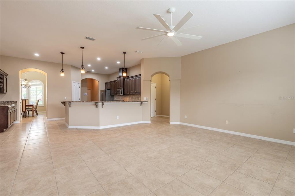 3343 West Locanda Circle New Smyrna Beach, FL 32168 - Photo 45 of 55 a view of a big room with wooden floor and a kitchen