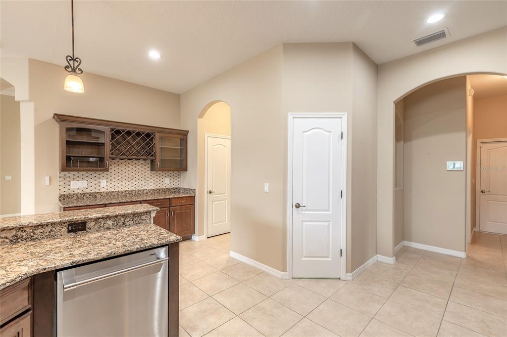 3343 West Locanda Circle New Smyrna Beach, FL 32168 - Photo 6 of 55 a kitchen with stainless steel appliances granite countertop a refrigerator and a stove top oven