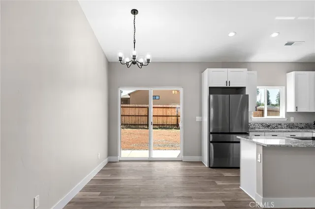 a view of a kitchen with a sink and refrigerator