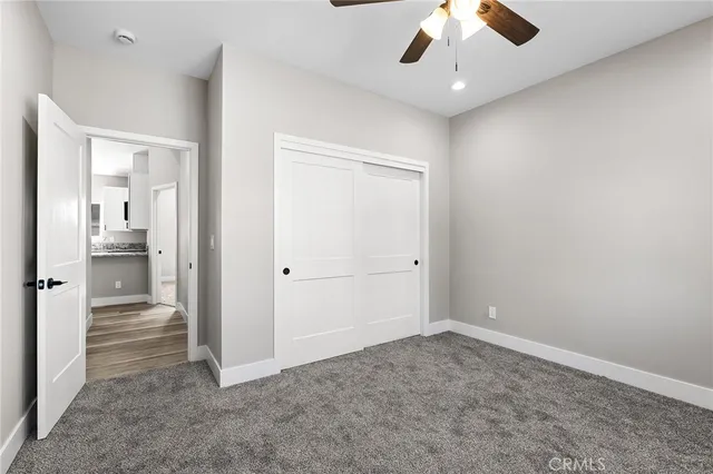wooden floor in an empty room and a bathroom