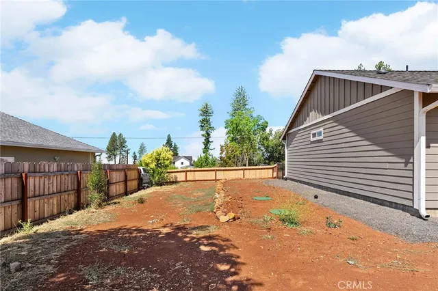a view of a house with a backyard