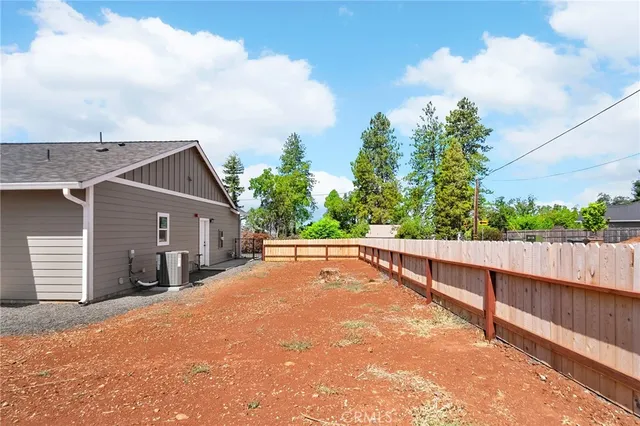 a view of a house with wooden fence