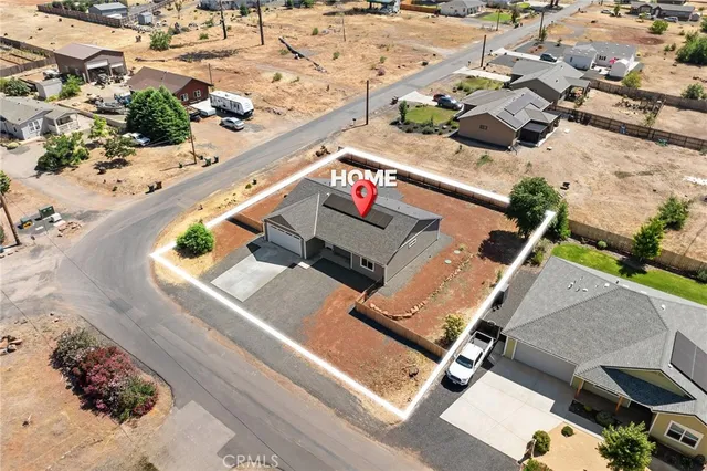 an aerial view of a house with outdoor space