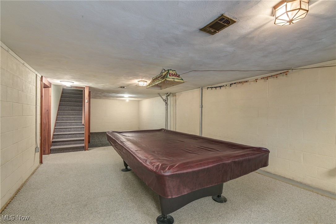 1103 Old Rockside Road Cleveland, OH 44134 - Photo 21 of 25 Recreation room with pool table, a textured ceiling, concrete block wall, and visible vents