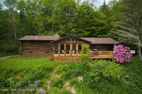 a front view of house with yard and trees