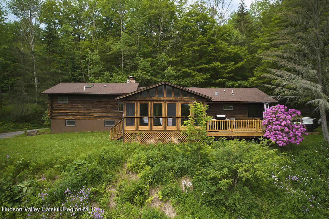 a front view of house with yard and trees