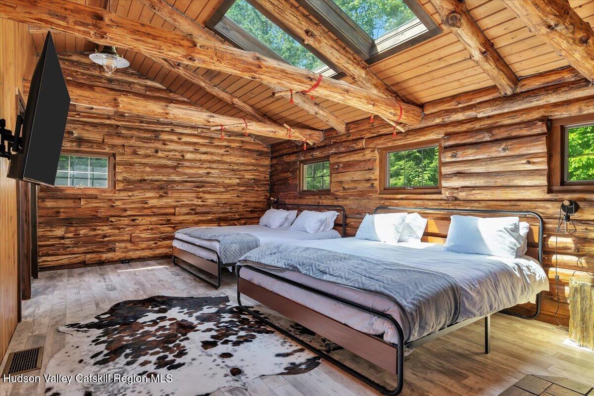 38 Woodchuck Road Roxbury, NY 12421 - Photo 17 of 33 a bedroom with a bed and wooden floor