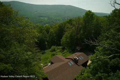 an aerial view of a house with a yard