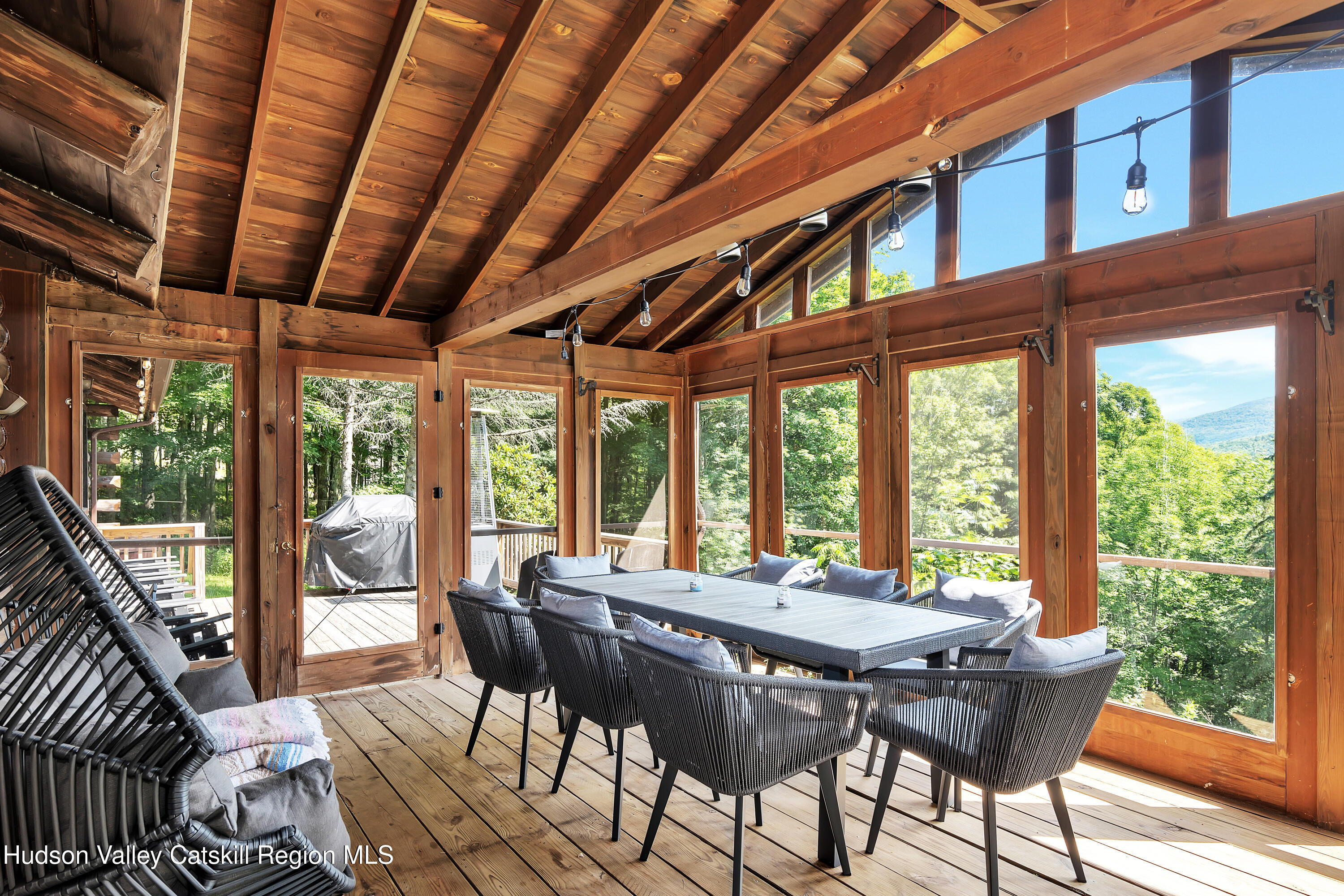 38 Woodchuck Road Roxbury, NY 12421 - Photo 2 of 32 a view of a dining room with furniture large windows and wooden floor