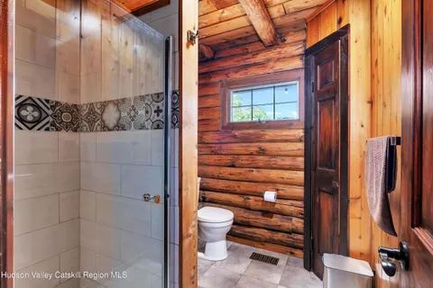 a bathroom with a toilet and a shower