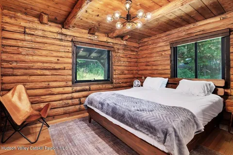 a bed sitting in a bedroom next to a window