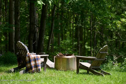 a view of a chairs and table in the back yard
