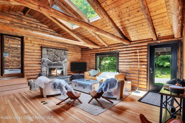 a living room with patio furniture and a large window