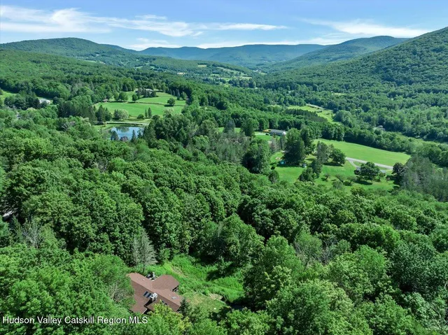 an aerial view of a house with a yard