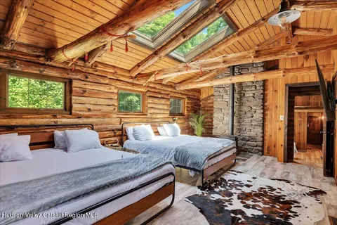 a bedroom with furniture and large windows