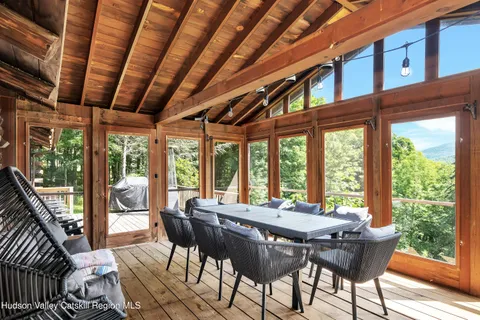 a view of a dining room with furniture large windows and wooden floor