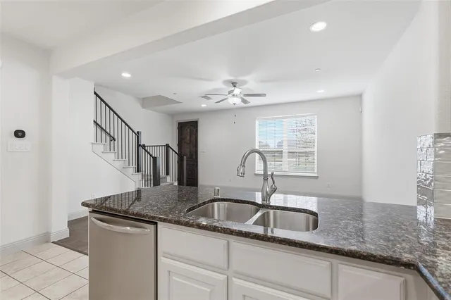 a kitchen with a sink and cabinets