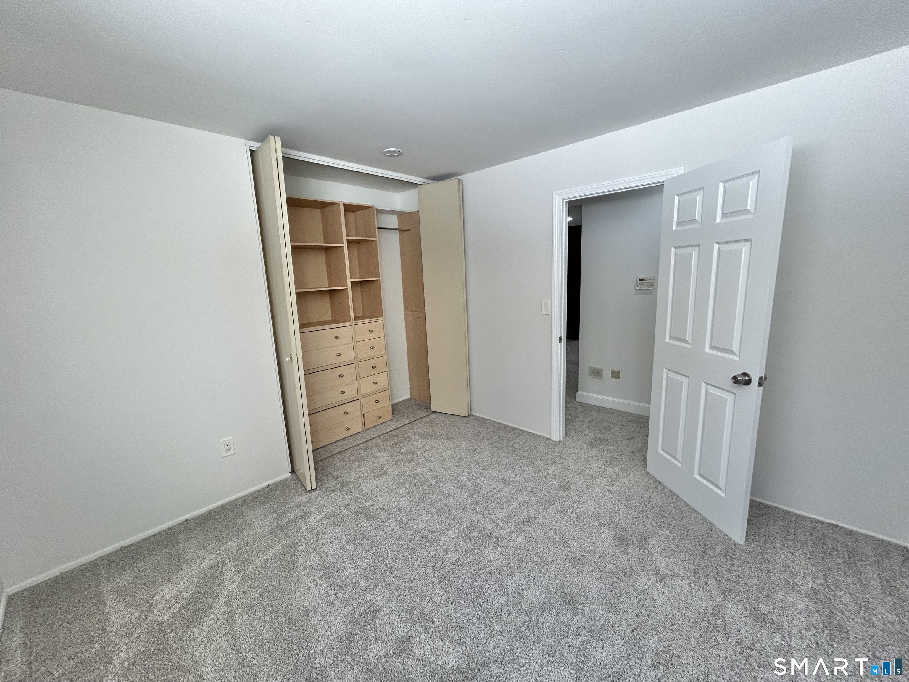229 Bacon Pond Road, Unit 312 Woodbury, CT 06798 - Photo 16 of 17 an empty room with a door
