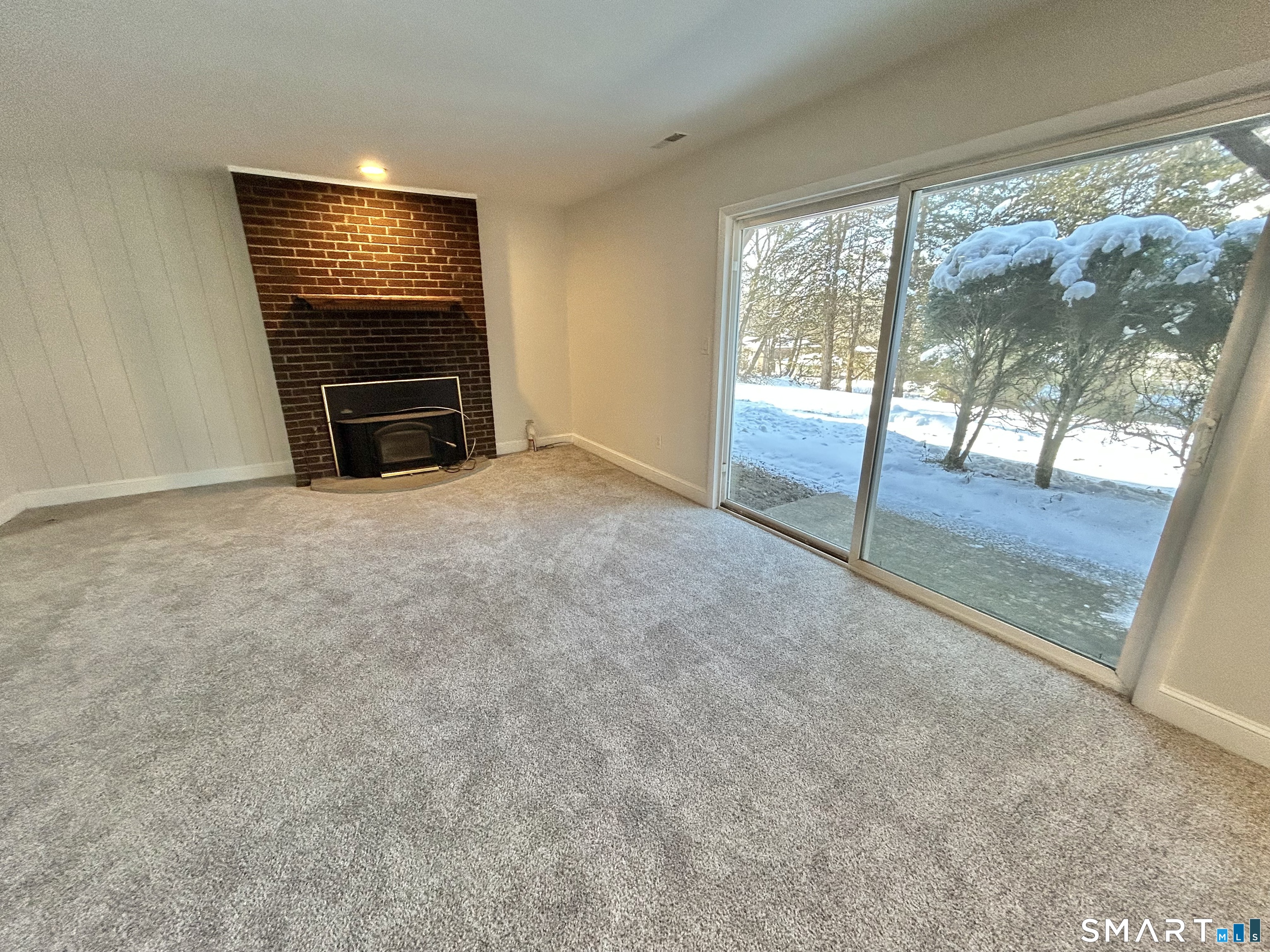 229 Bacon Pond Road, Unit 312 Woodbury, CT 06798 - Photo 2 of 17 an empty room with large windows