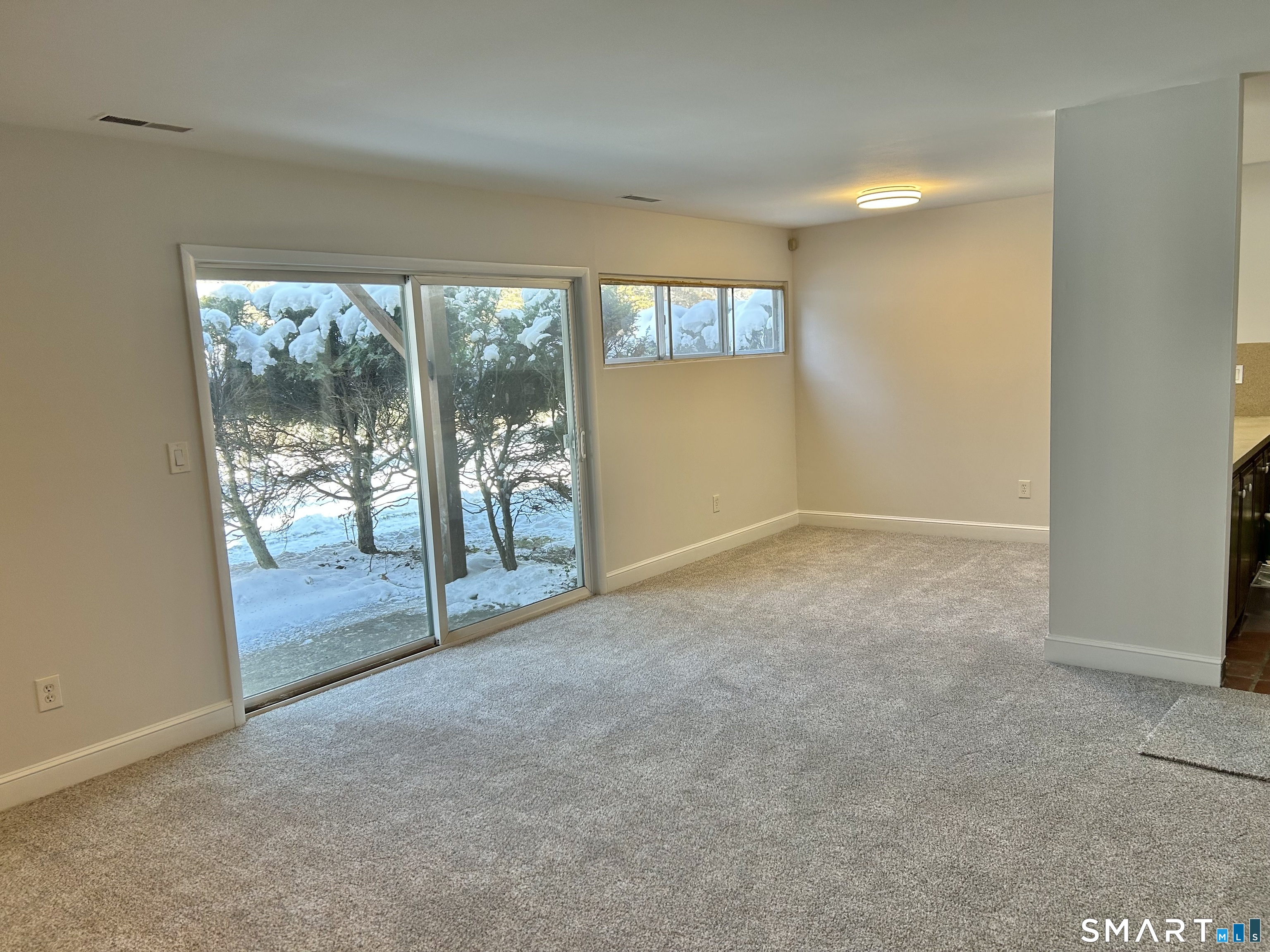 229 Bacon Pond Road, Unit 312 Woodbury, CT 06798 - Photo 7 of 17 an empty room with windows