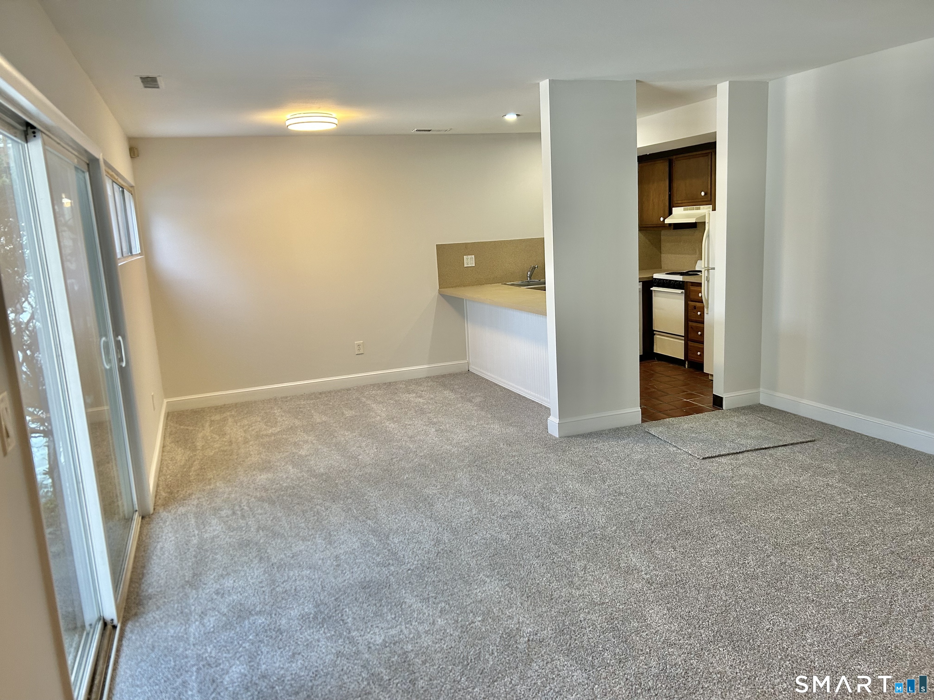 229 Bacon Pond Road, Unit 312 Woodbury, CT 06798 - Photo 8 of 17 an empty room with windows