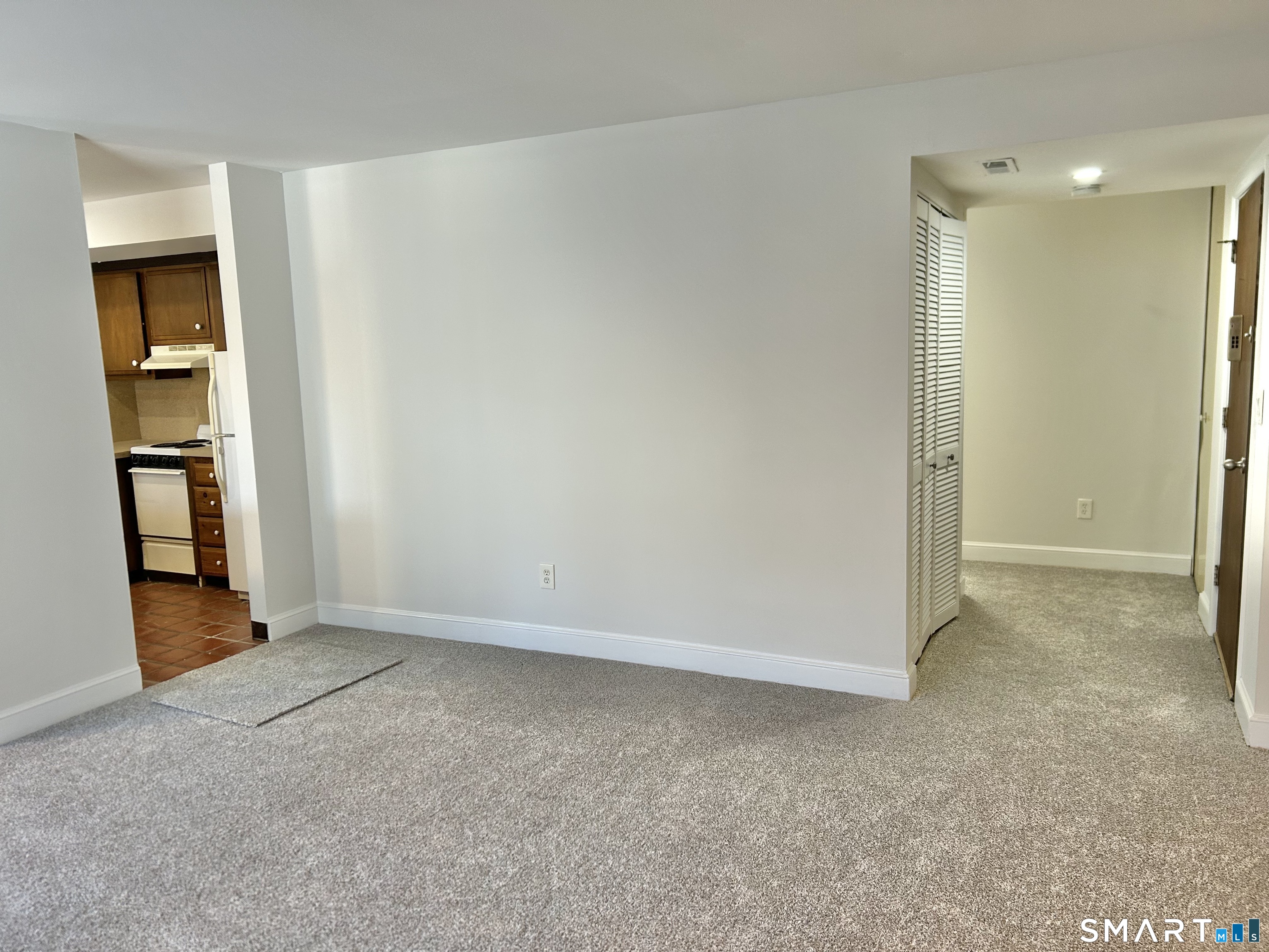 229 Bacon Pond Road, Unit 312 Woodbury, CT 06798 - Photo 9 of 17 an empty room with closet and mirrors