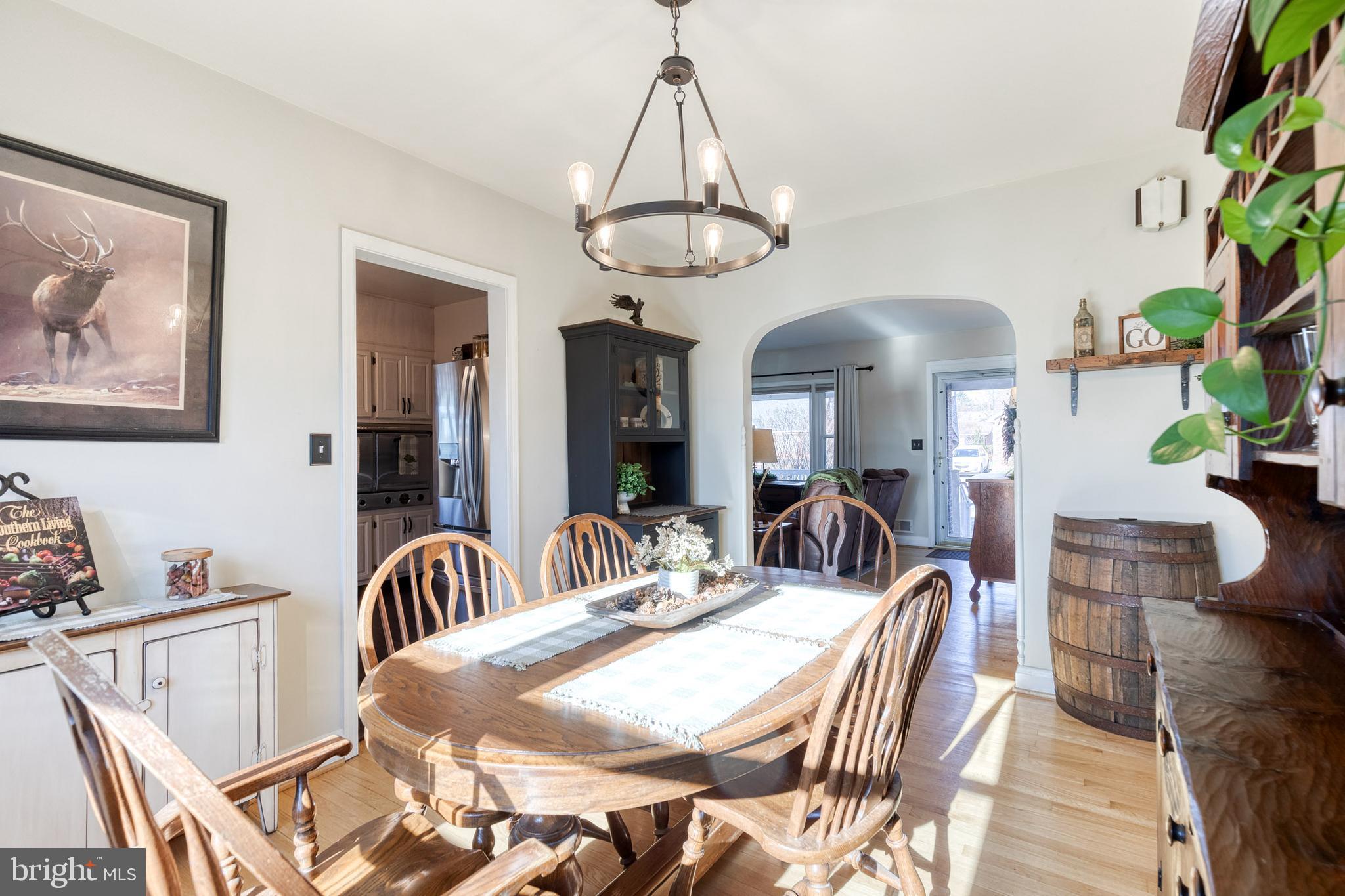 1911 Sunberry Road Dundalk, MD 21222 - Photo 12 of 38 a view of a dining room with furniture wooden floor and chandelier