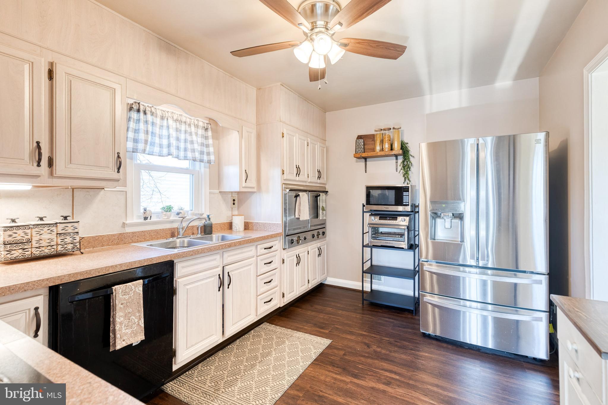 1911 Sunberry Road Dundalk, MD 21222 - Photo 15 of 38 a kitchen with stainless steel appliances granite countertop a refrigerator and a stove top oven