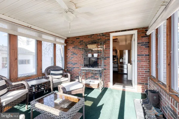 a dining room with furniture and large windows