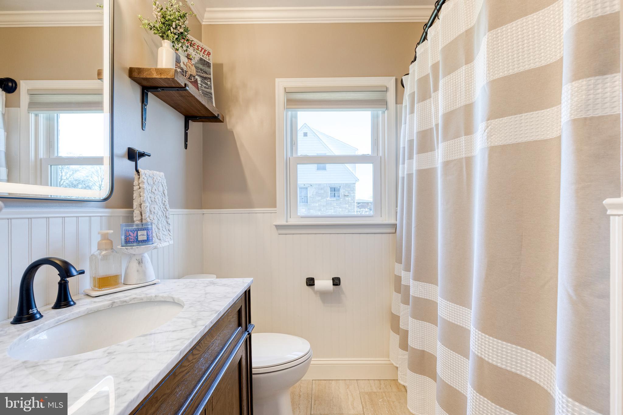 1911 Sunberry Road Dundalk, MD 21222 - Photo 20 of 38 a bathroom with a granite countertop sink toilet a mirror and shower