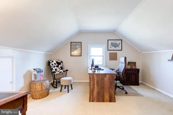 a living room with furniture and a piano