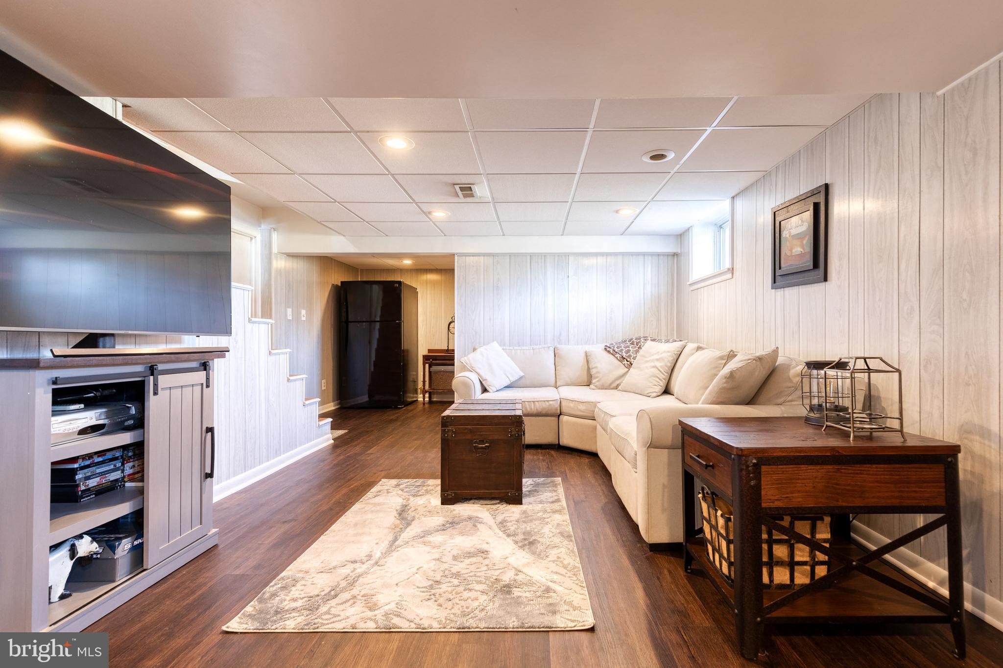 1911 Sunberry Road Dundalk, MD 21222 - Photo 27 of 38 a living room with furniture a fireplace and a flat screen tv