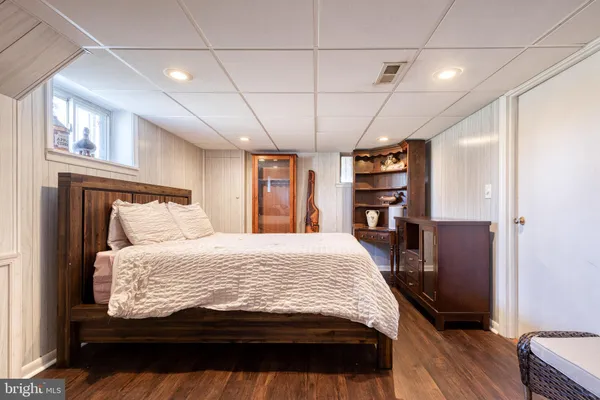 a bedroom with a bed and a television