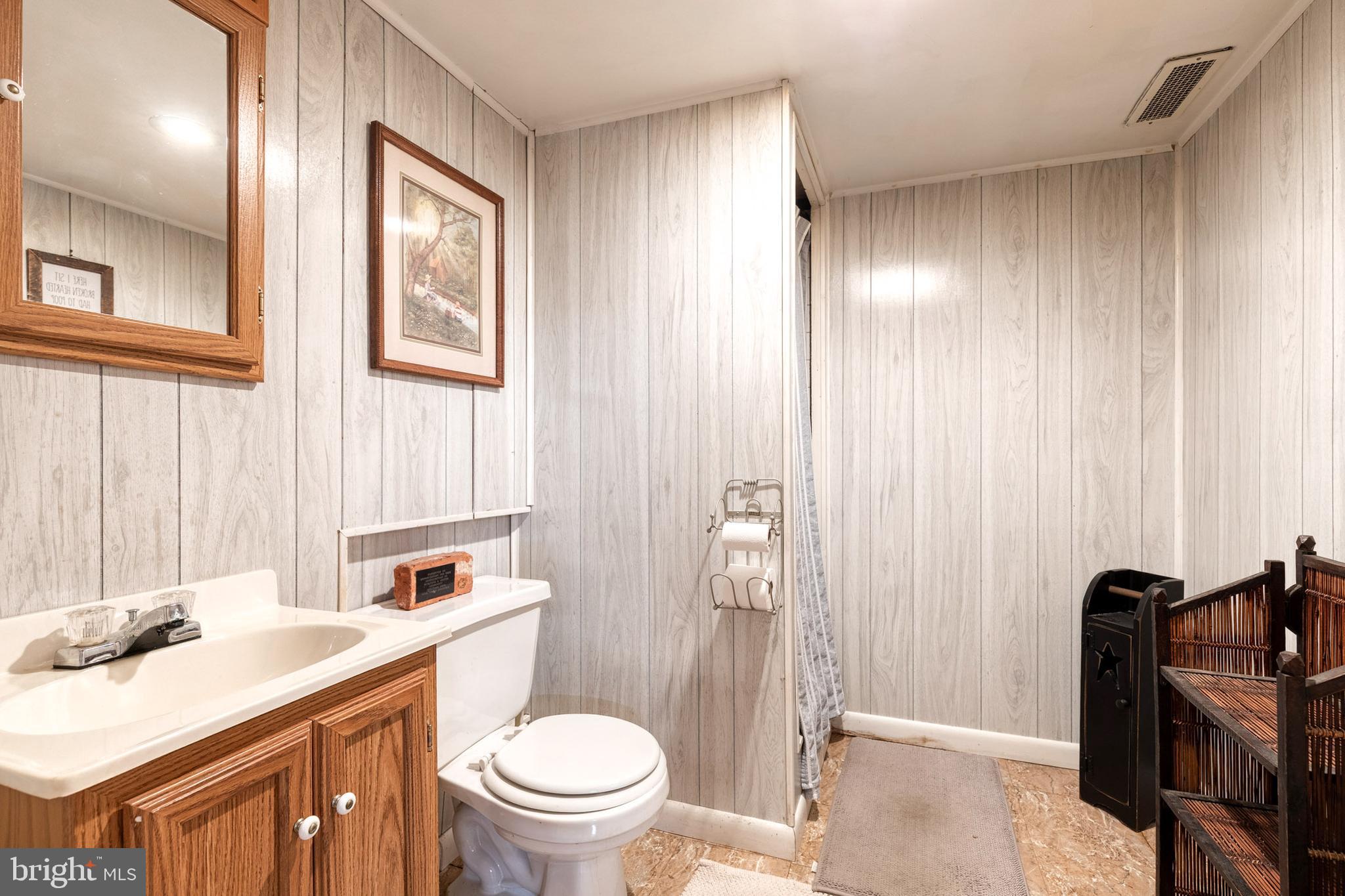1911 Sunberry Road Dundalk, MD 21222 - Photo 30 of 38 a bathroom with a sink a toilet and shower