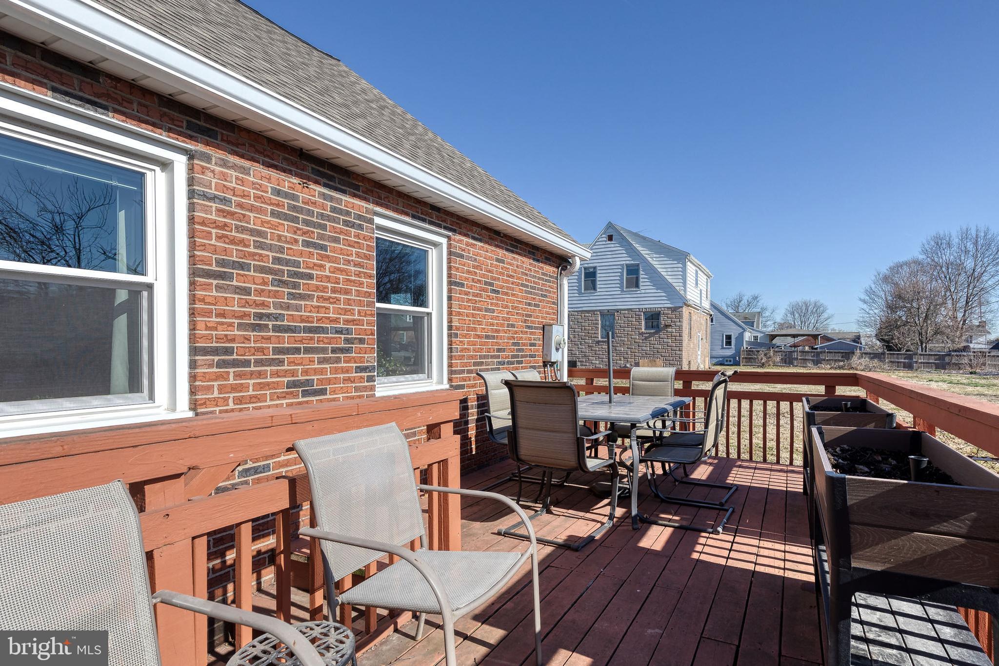 1911 Sunberry Road Dundalk, MD 21222 - Photo 37 of 38 a view of a patio with table and chairs with wooden floor and fence