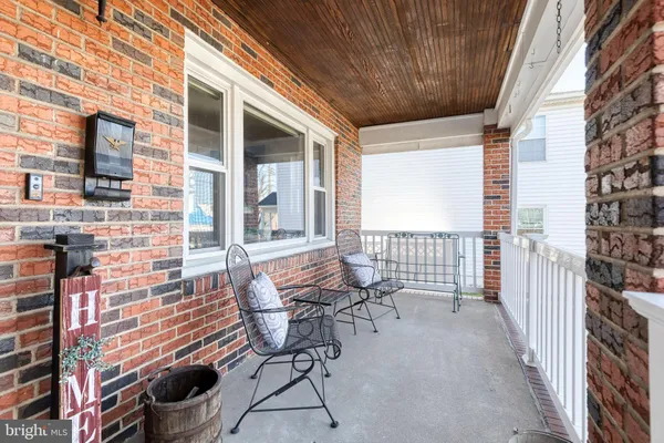 a balcony with chairs and with outdoor seating