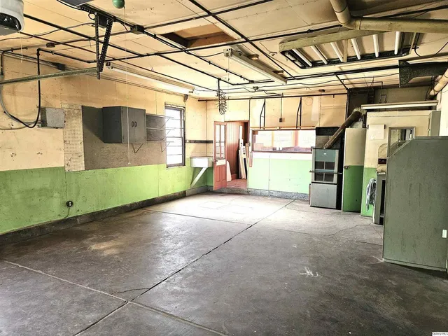 a bed room with a bed and a large window