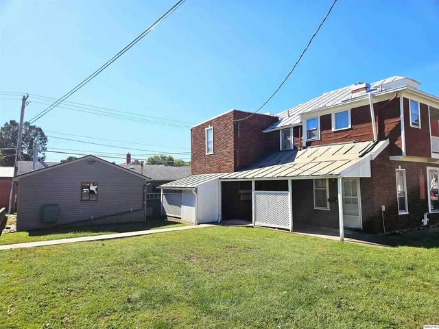 a view of a garage with wooden table and chairs